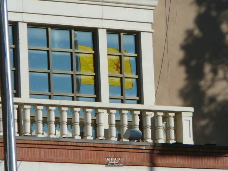window panes in a building with an umbrella sticking out of them