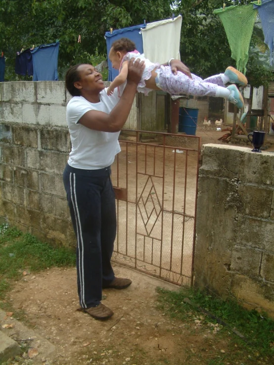 a woman holding a child while looking at the back of another