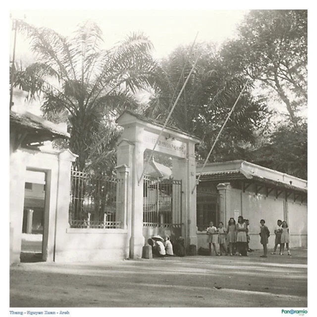 old po of people standing in front of a building