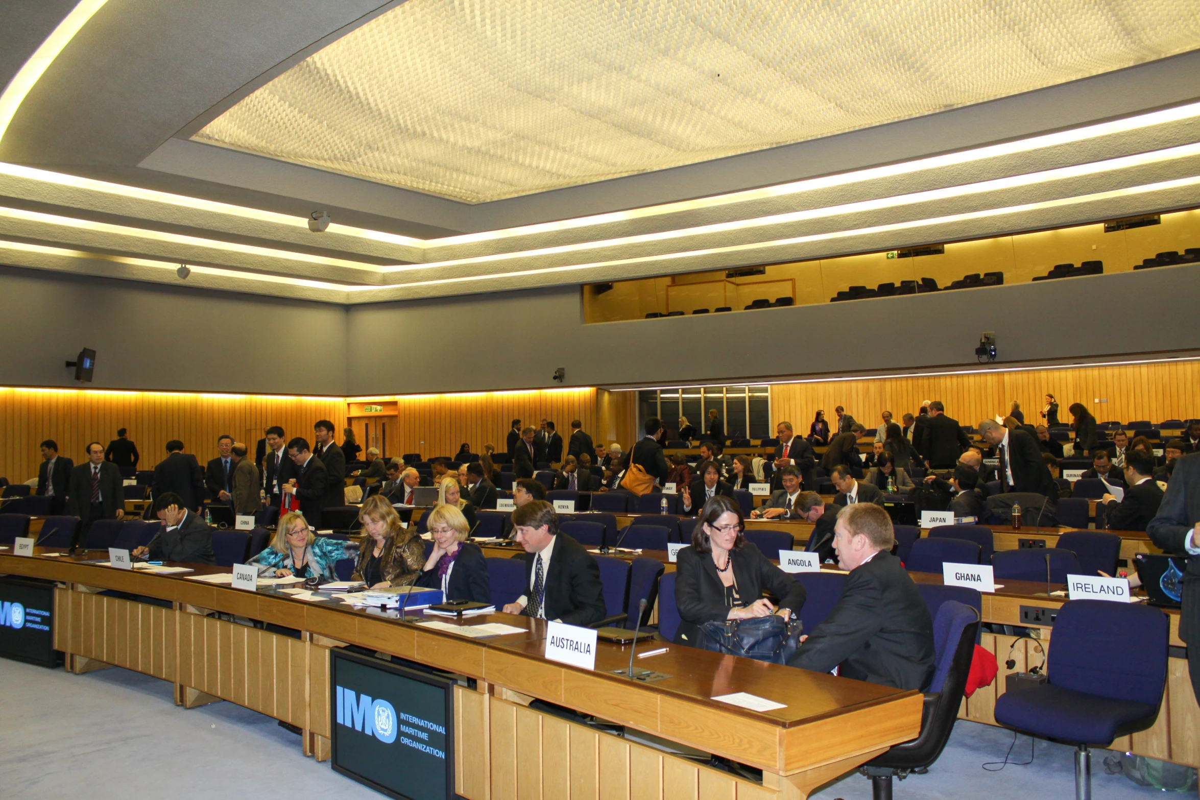 a group of people sit in rows in a conference room