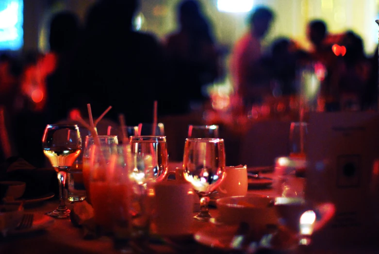 people sitting at tables and drinking drinks at an event