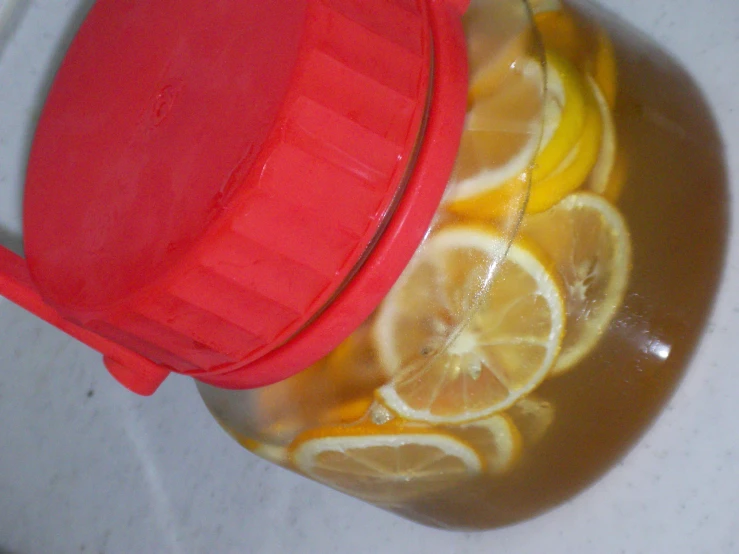 a red pot with lemons and lemon juice