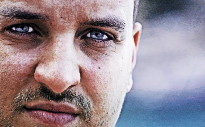 closeup of man with beard and blue eyes