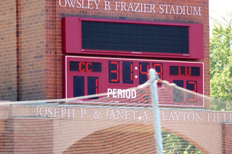 a view from behind a fence looking at the scoreboard