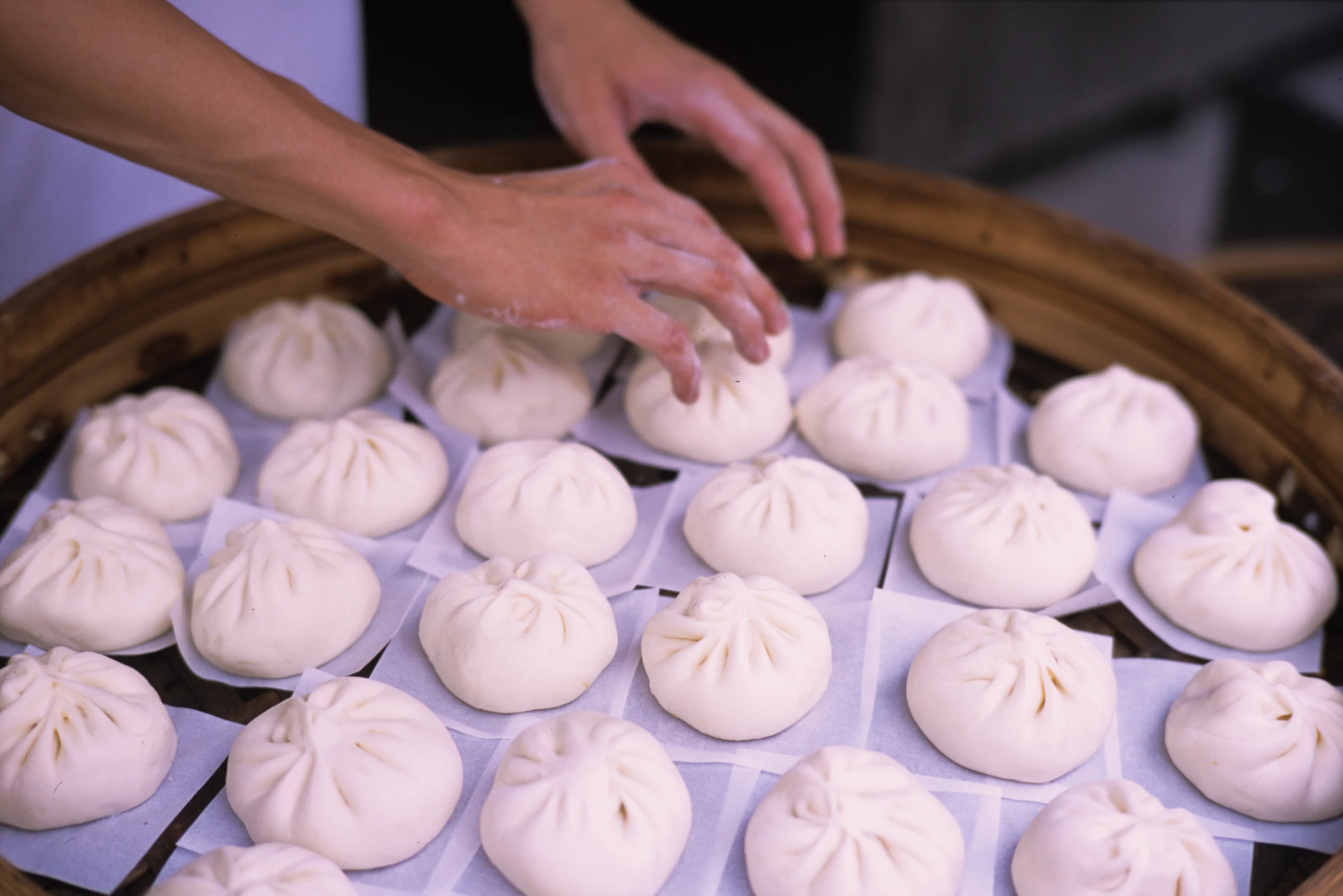 a bamboo basket with dumplings being prepared in it