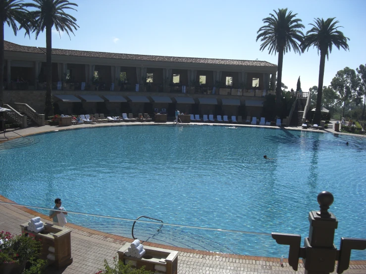 a large pool next to a el with umbrellas