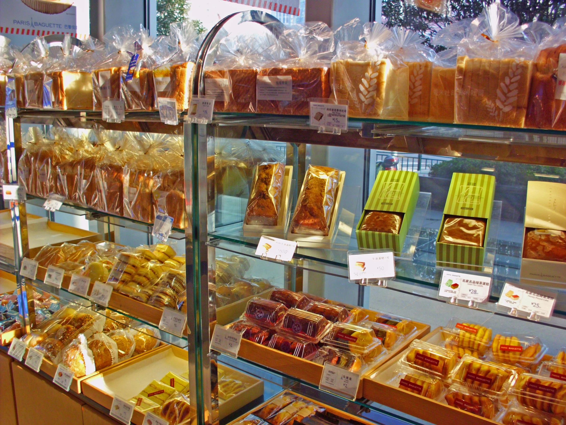 various pastries displayed in display cases on shelves