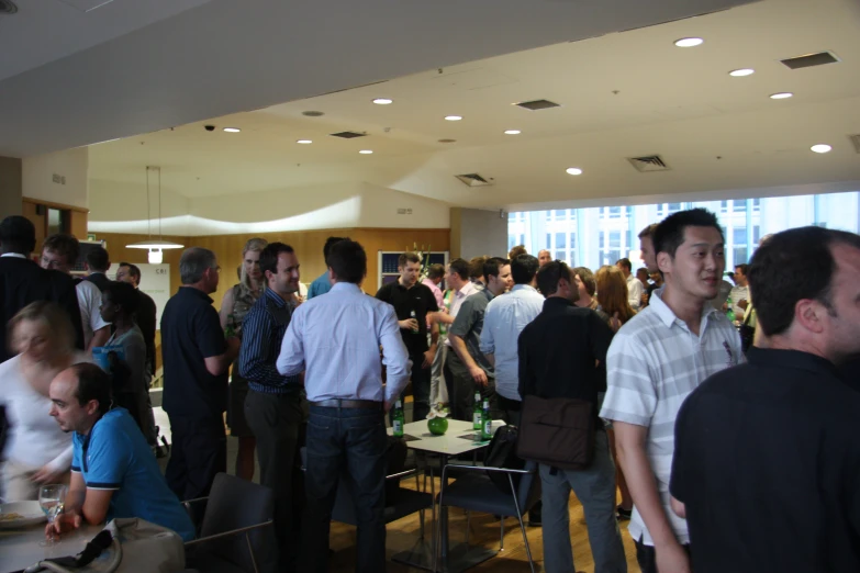 a large group of people standing in a room