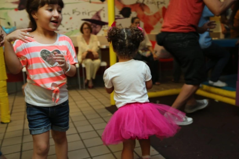 two children dancing at an open air event