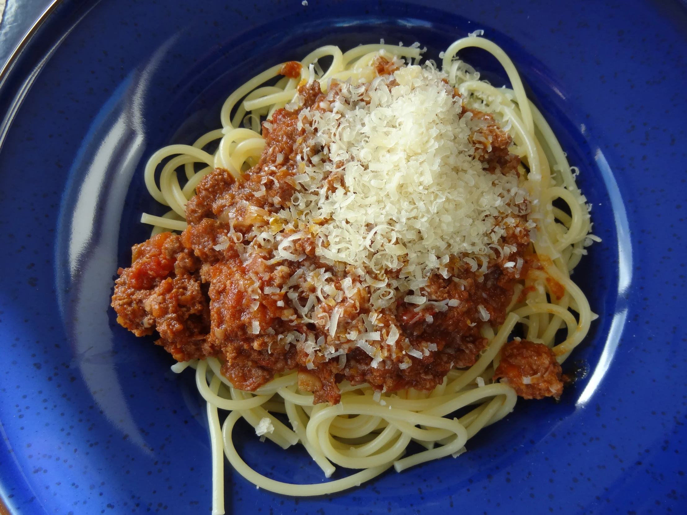 spaghetti with tomato sauce and a dollop of cheese