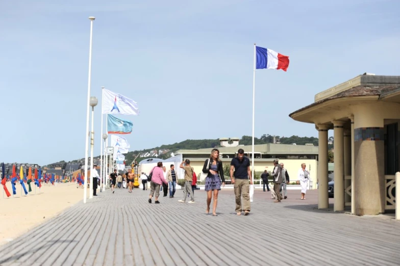 the people are walking together on the boardwalk