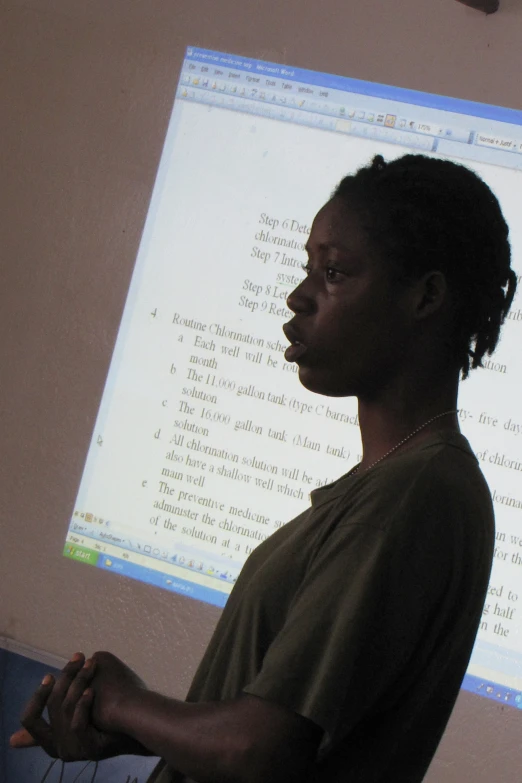 a person standing in front of a projection screen