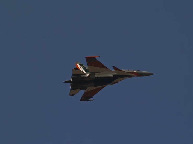 an american jet in flight with a bright red tail