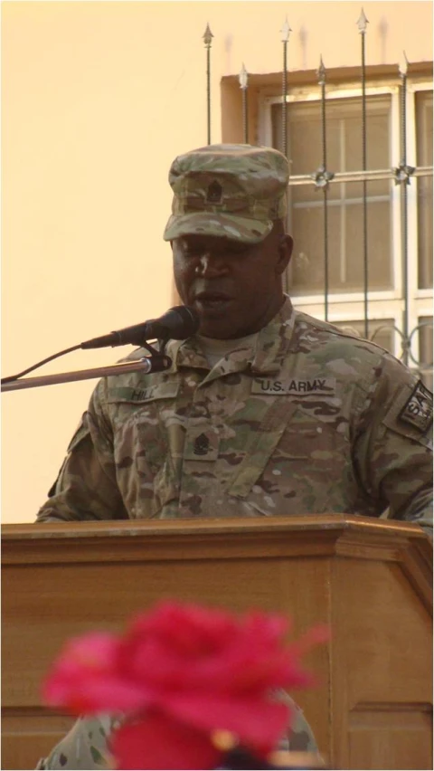 a soldier is speaking into the microphone at a podium