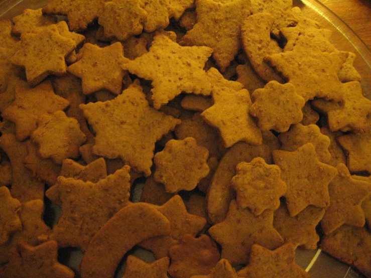 cookies like star and cross cookies are on a metal rack