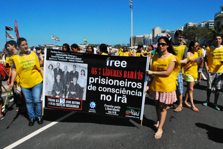 several people in yellow shirts and others wearing yellow shirts are walking