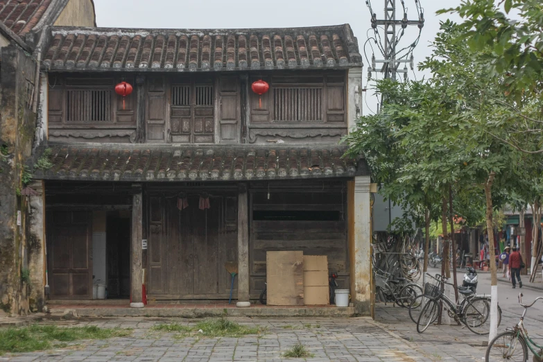 an old house with a couple of red balloons on it's roof