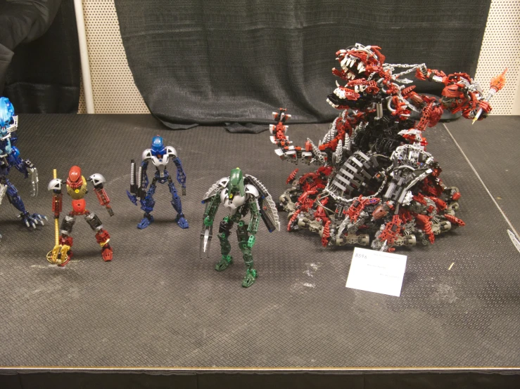action figures and a miniature model robot suit displayed