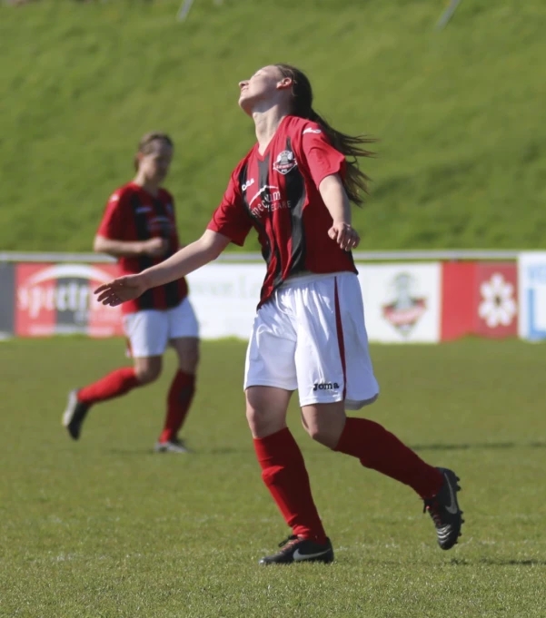 the two girls are playing a soccer game