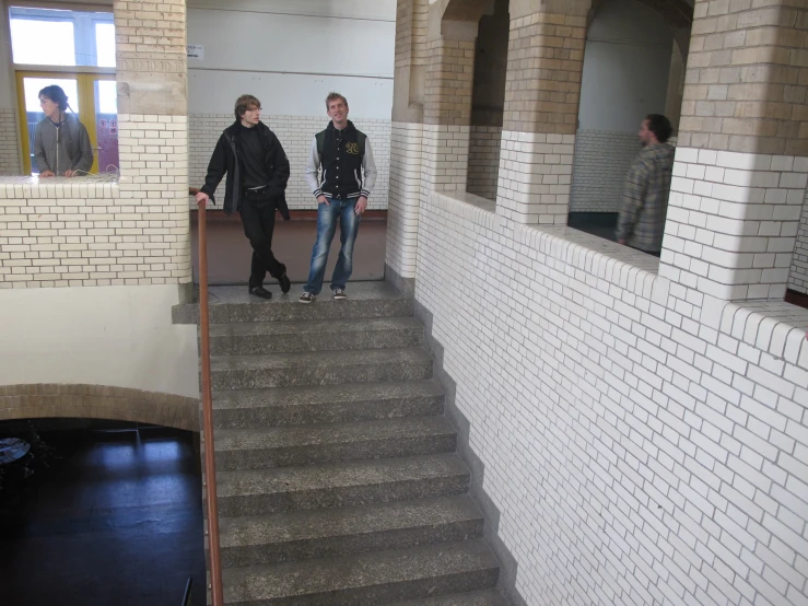 two young people are walking up the stairs