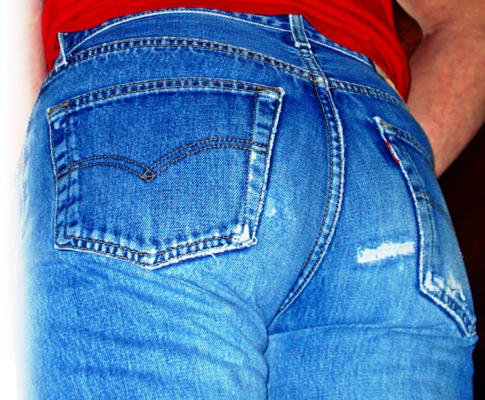 the bottom portion of a persons jeans jeans with holes in it