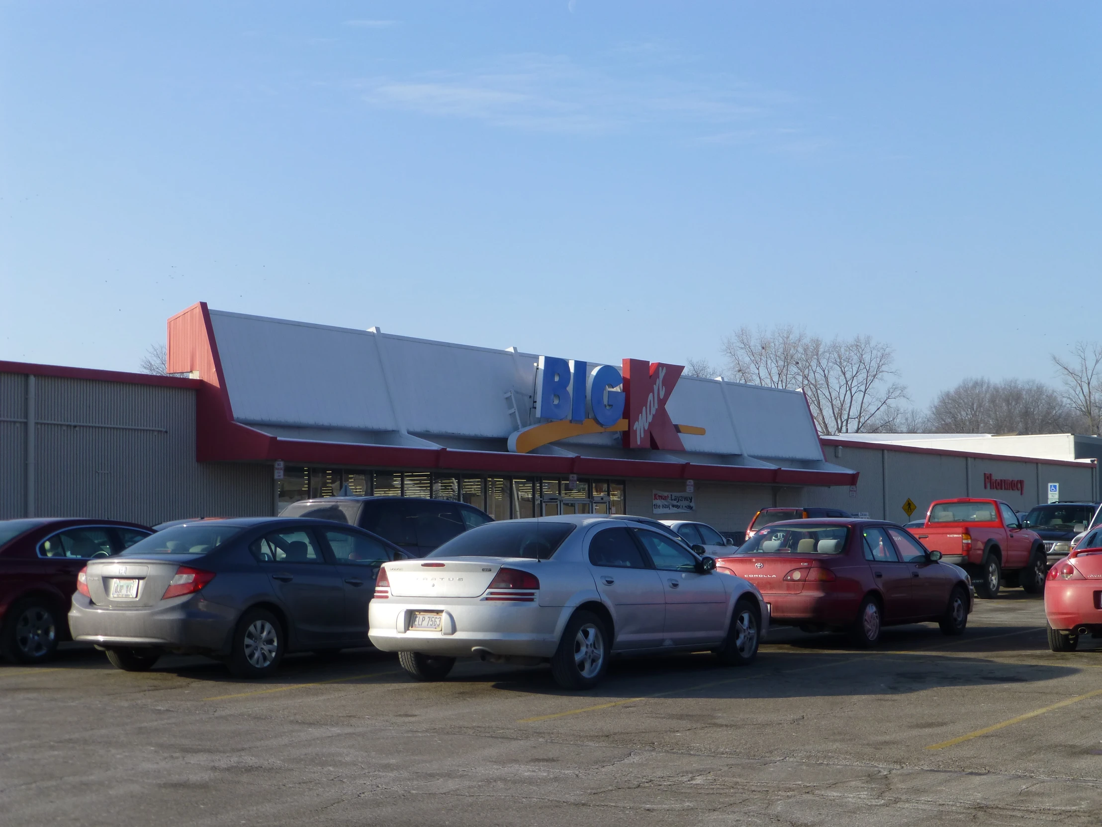 the front view of a car dealership and its parking lot