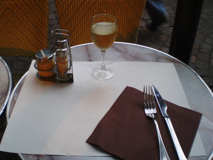 a table with two glass bottles and silverware