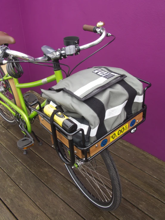 a bike with a large duffle on the front with the seat and back