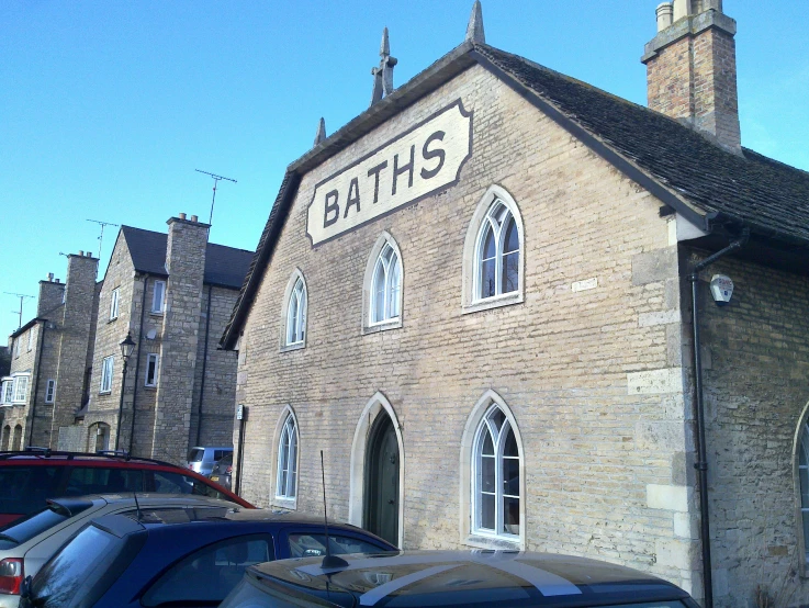 a brown building with two towers on the top