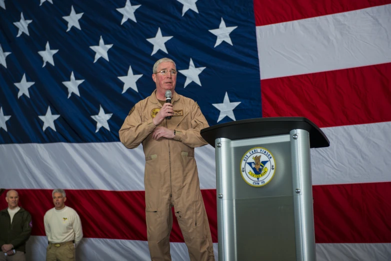 a man in an uniform standing in front of a podium