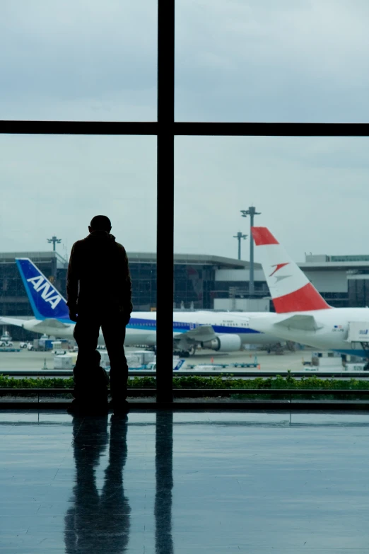 a man that is standing in front of an airport