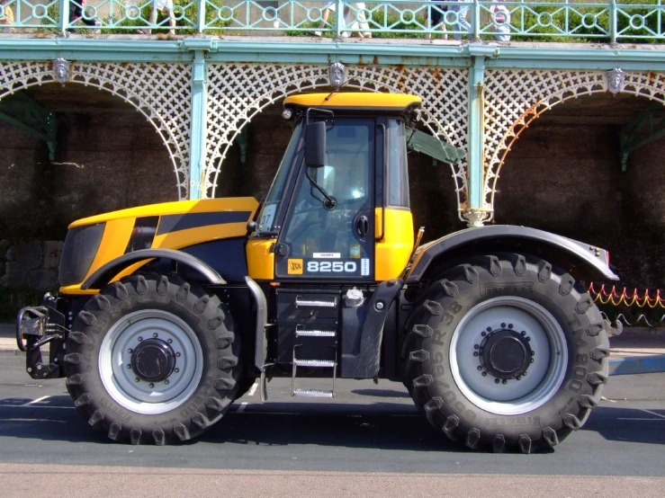 the large tractor is parked next to a building