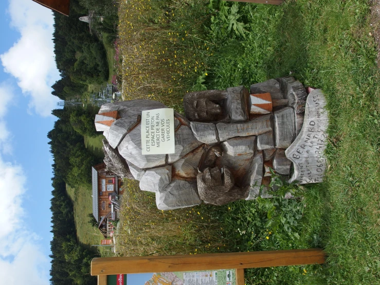 an outdoor monument with signs about a trail