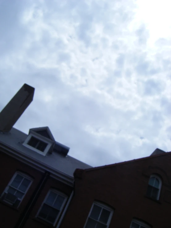 an image of a building with the cloudy sky behind it