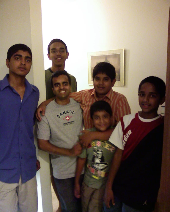 a group of young people standing together in a room