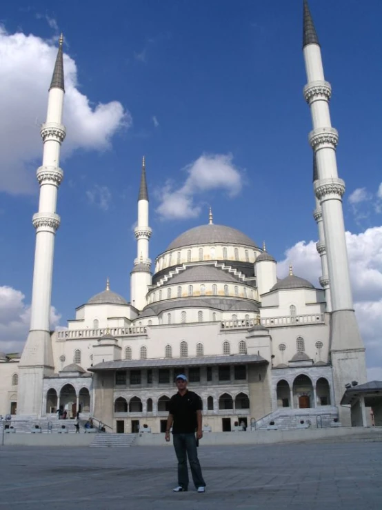 a man is standing in front of some buildings