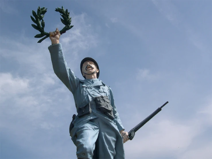 a statue has leaves coming out of it and a bird flying in the sky