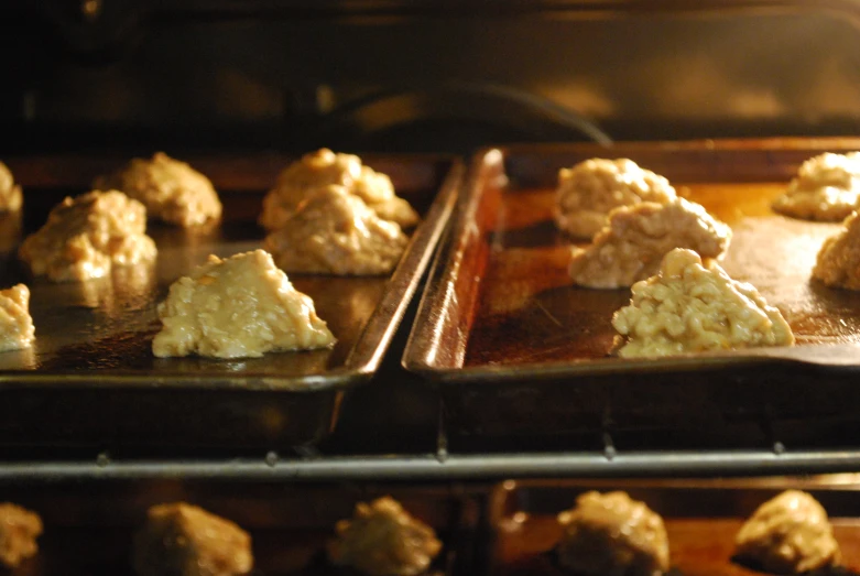 several trays with many muffins sitting on a table