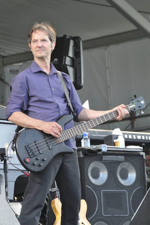 a man plays his guitar on stage