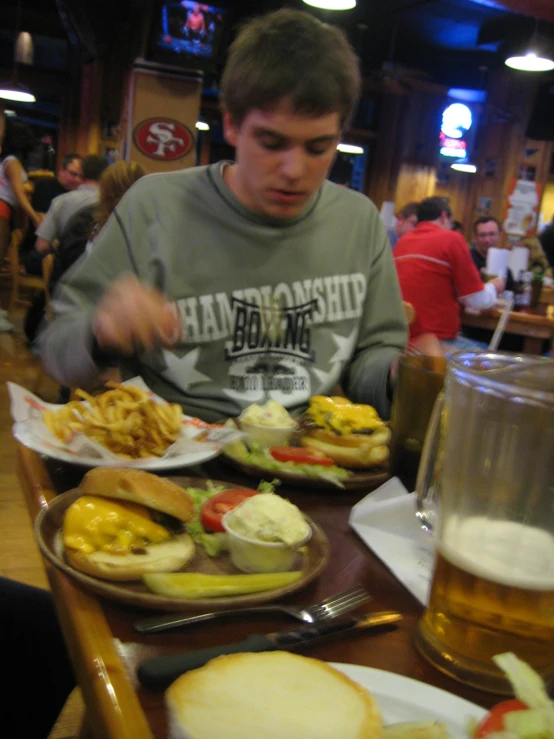 a man sitting at a table with a lot of food