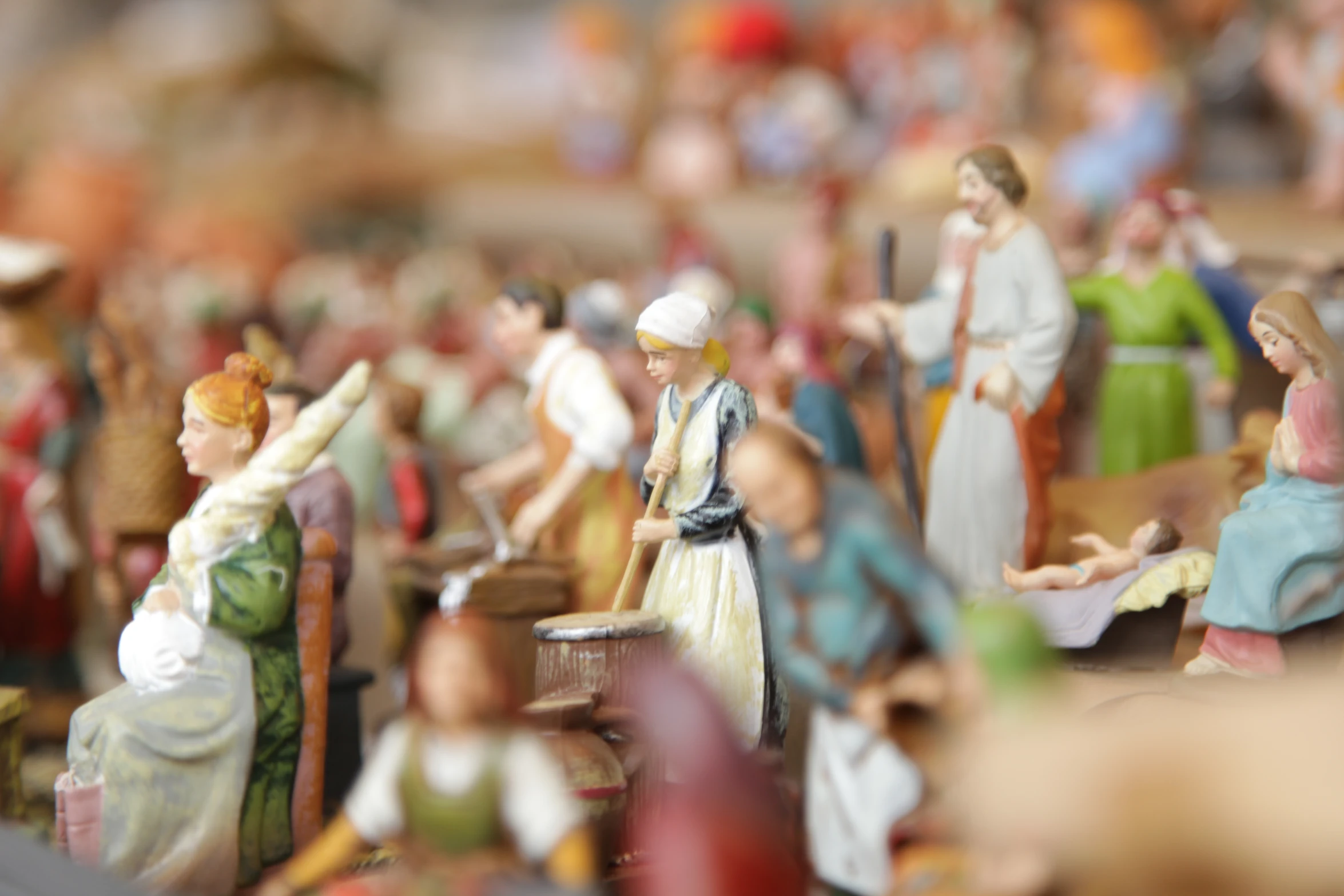 a close up of many figurines of people near one another