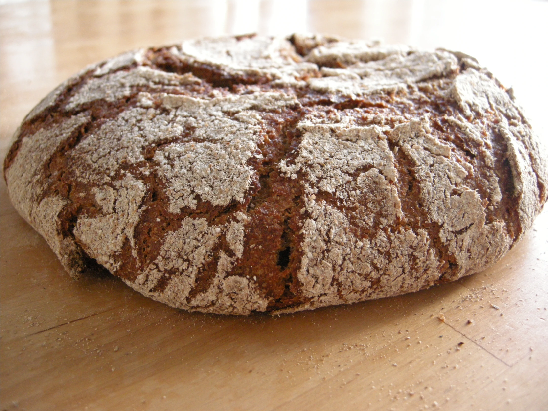 a loaf of bread sitting on top of a wooden table