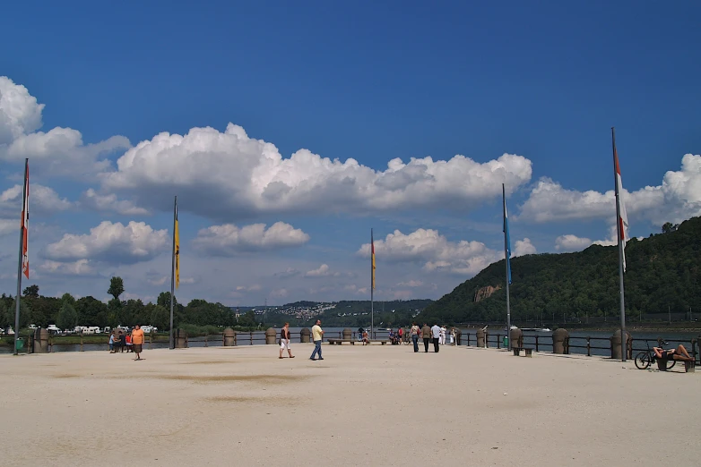 a person flying a kite while others walk by