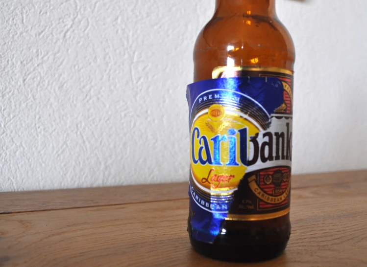 a close up of a beer on a wooden table