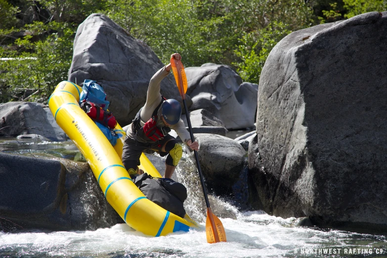 a man is holding onto an inflatable tube and getting ready to go down a water slide