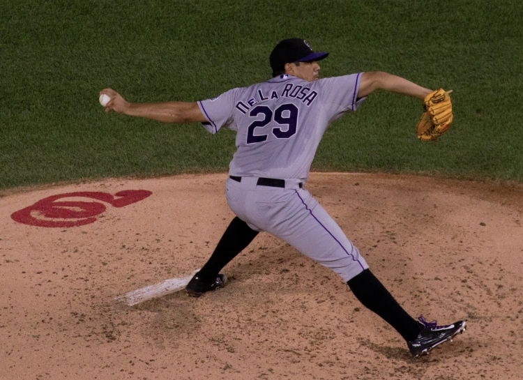 a pitcher throwing the baseball in a game