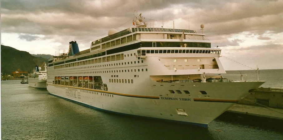 a large white boat is docked at the dock