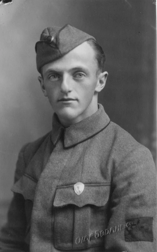 an old black and white po of a man in military dress uniform