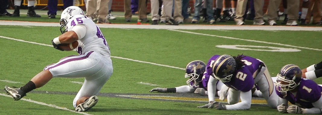 some guys playing a game of football on the field