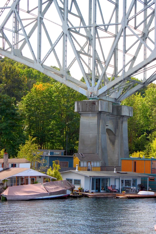 boats are in a body of water below a large metal structure